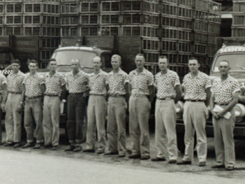 Sanderson Farms workers standing infront of the Purina Feed and Seed plant circa 1951