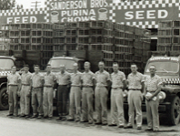 Sanderson Farms workers standing infront of the Purina Feed and Seed plant circa 1951